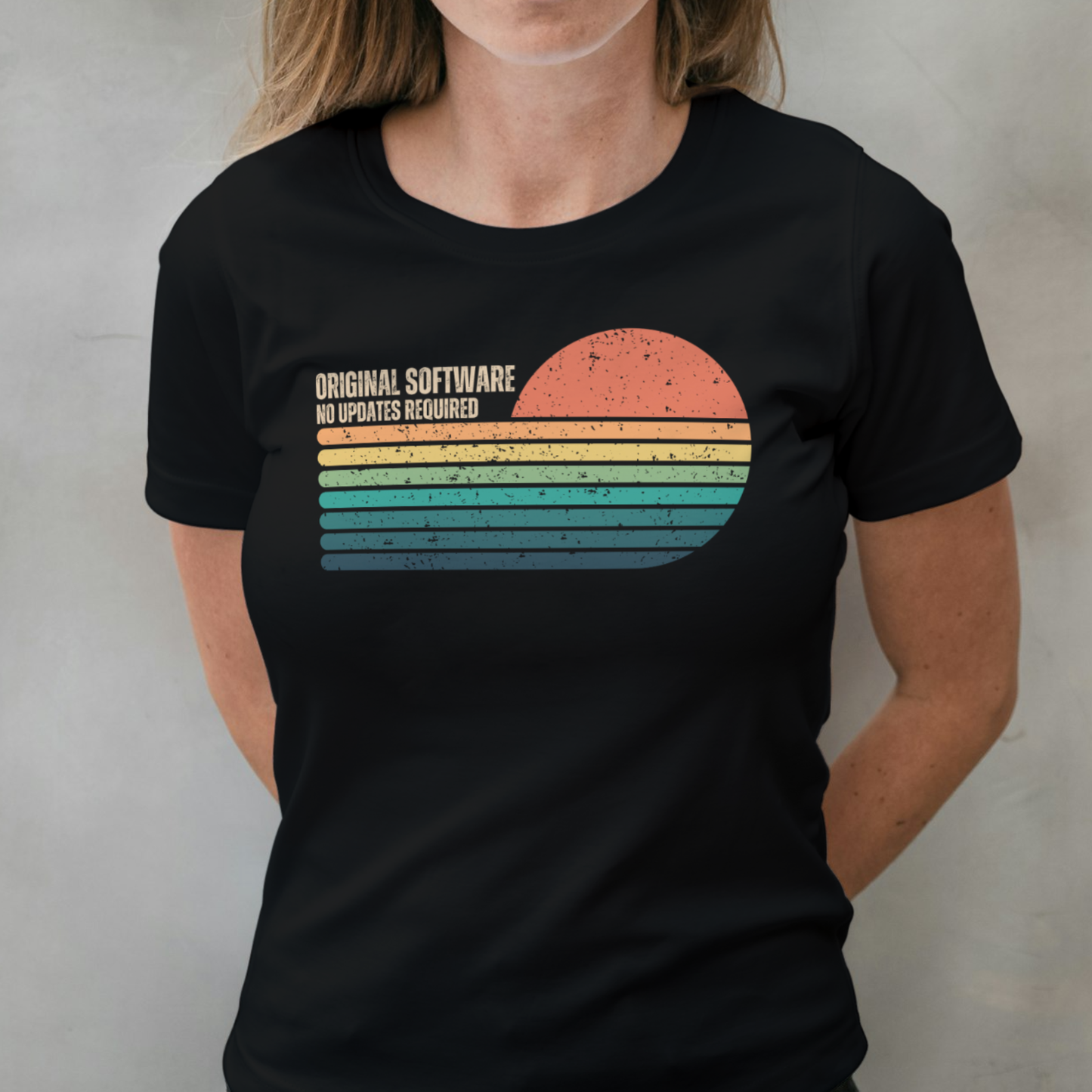 Person wearing a black t-shirt with a colorful graphic and text on a plain background