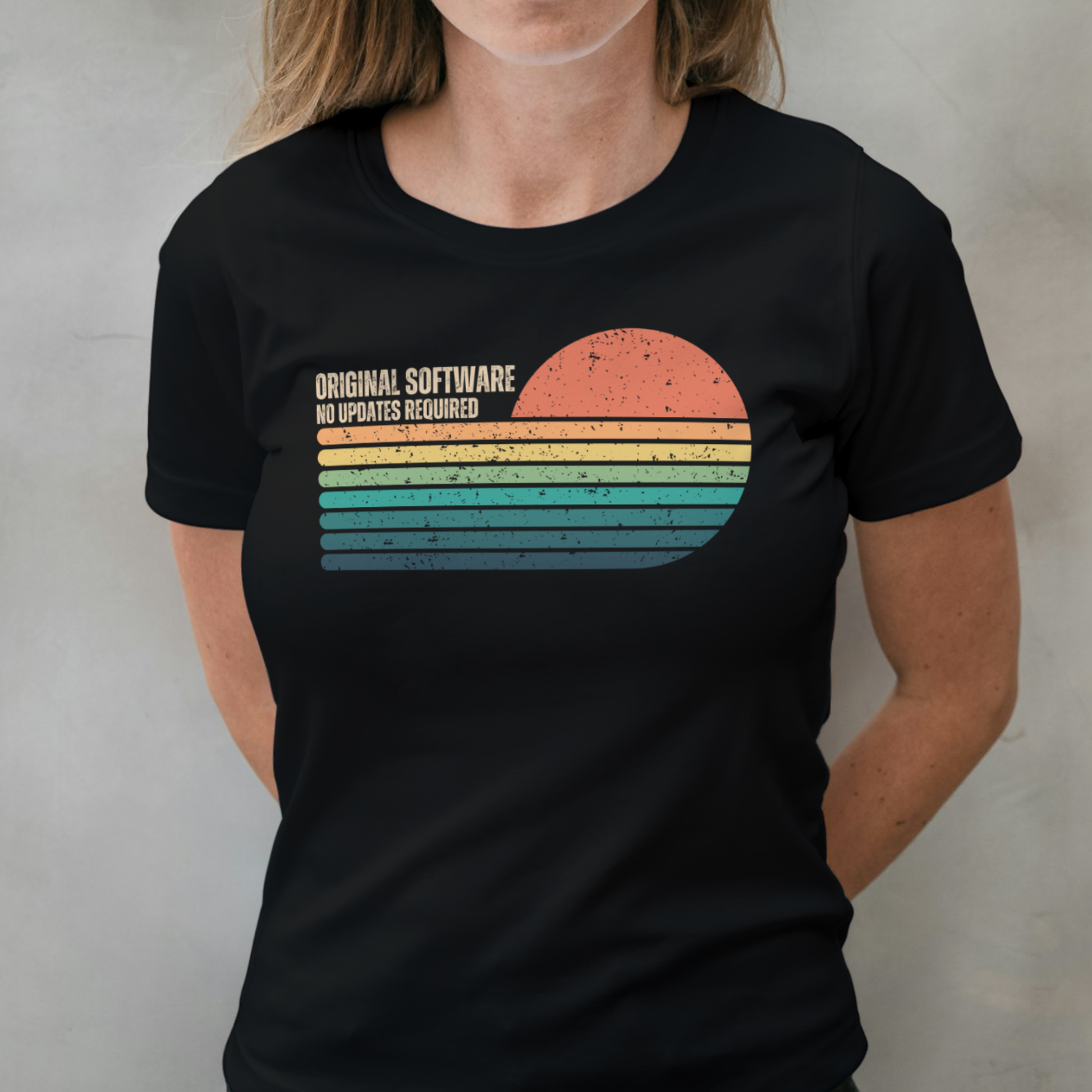 Person wearing a black t-shirt with a colorful graphic and text on a plain background