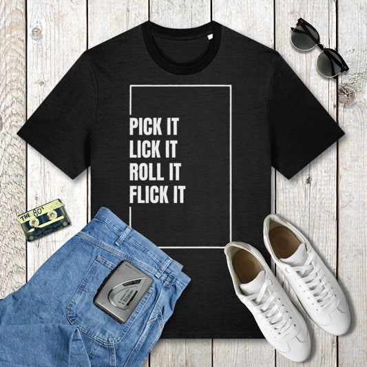 Black t-shirt with text 'Pick it Lick it Roll it Flick it' on a wooden surface with jeans, sneakers, and sunglasses.