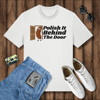 White t-shirt with 'Polish It Behind The Door' graphic, blue jeans, white sneakers, and sunglasses on a wooden surface.