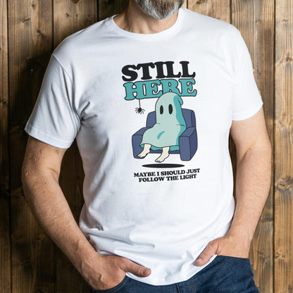 Person wearing a white t-shirt with a ghost graphic and text against a wooden background
