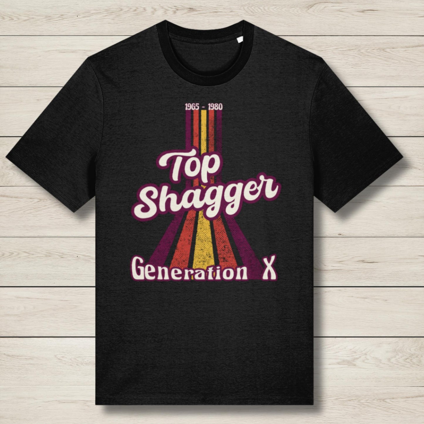 Black t-shirt with 'Top Shagger Generation X' design on a wooden surface
