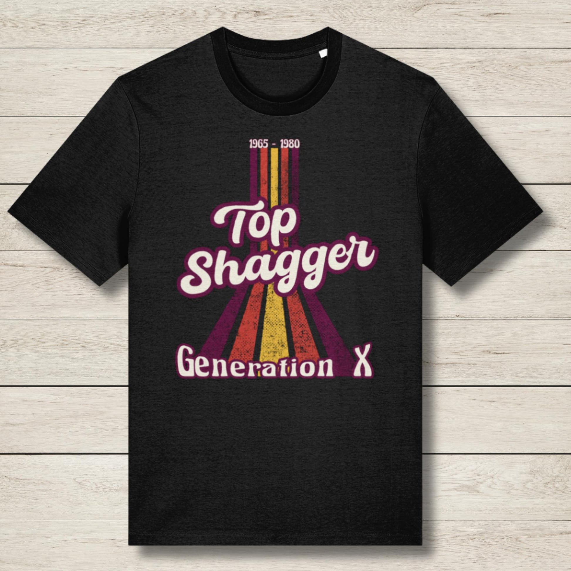 Black t-shirt with 'Top Shagger Generation X' design on a wooden surface