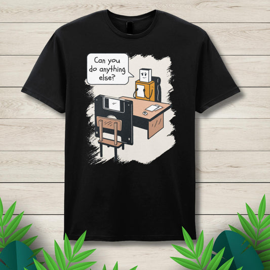 Black t-shirt with a graphic design of a robot and floppy disk on a wooden background