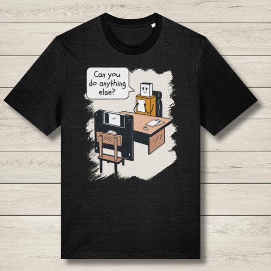 Black t-shirt with a cartoon design of a robot and computer on a wooden surface