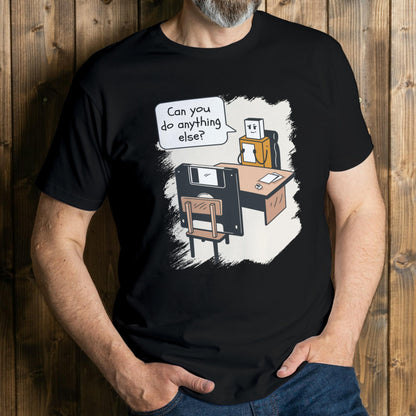 Person wearing a black t-shirt with a graphic design of a robot and text on a wooden background
