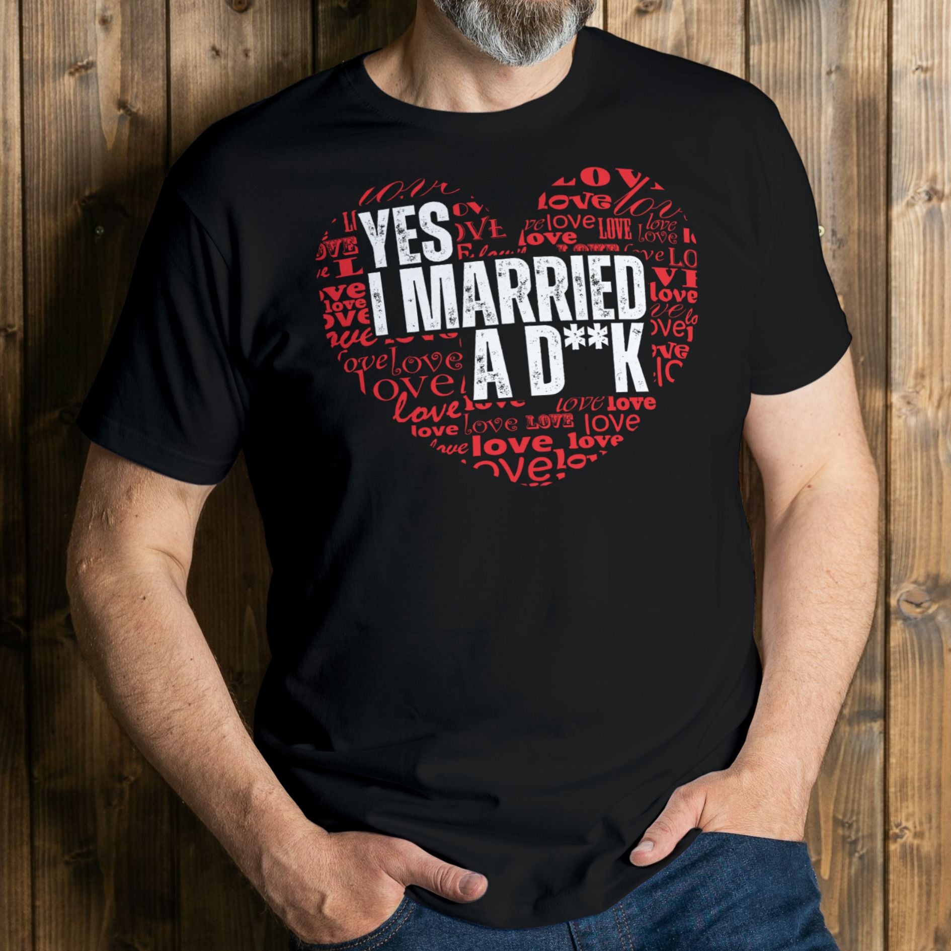 Person wearing a black t-shirt with red and white text against a wooden background