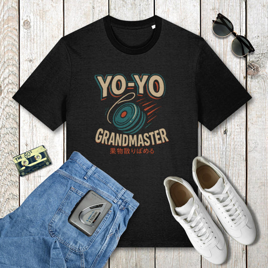 Black t-shirt with 'YO-YO Grandmaster' design on a wooden surface with jeans, sneakers, and a cassette tape.