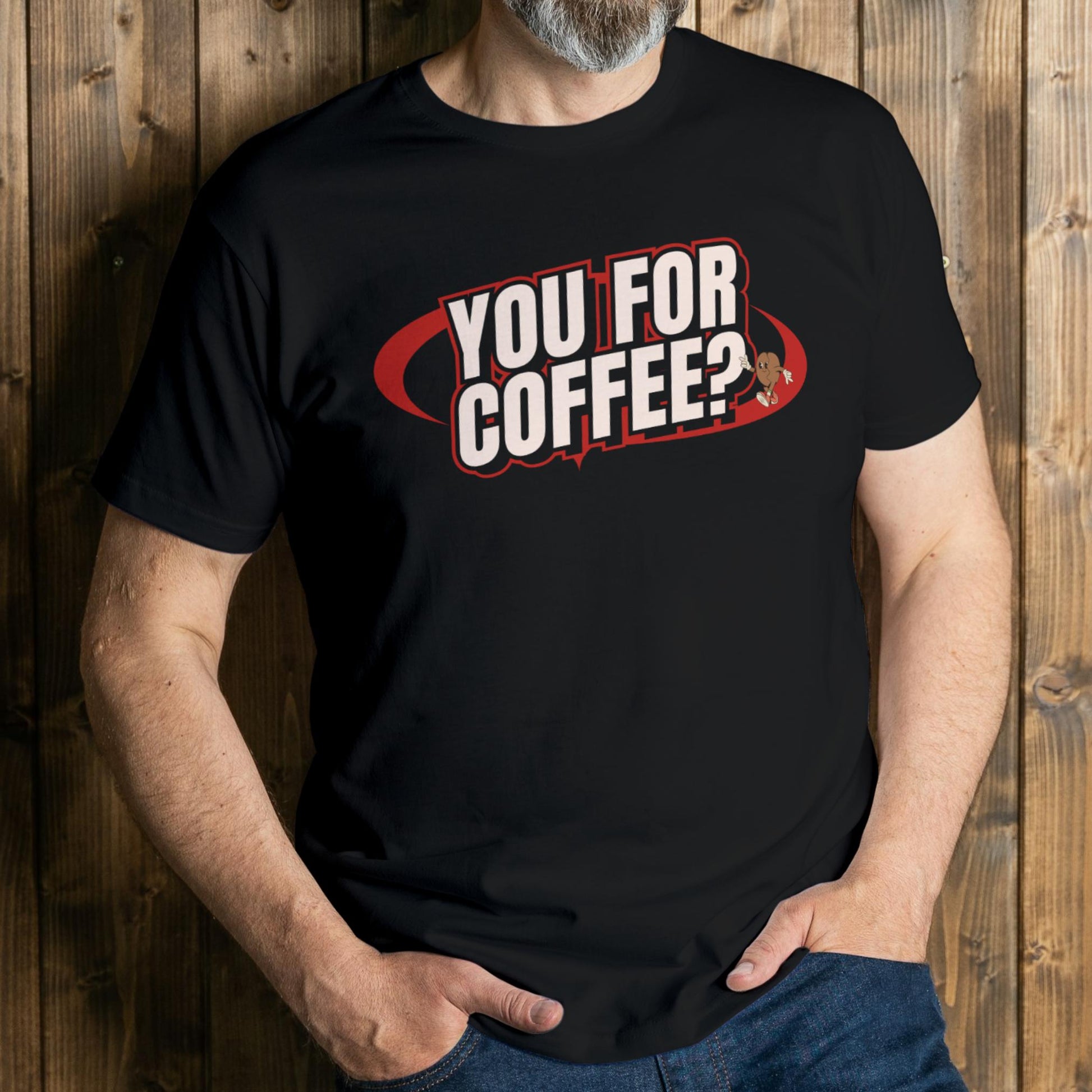 Person wearing a black t-shirt with 'YOU FOR COFFEE?' text against a wooden background